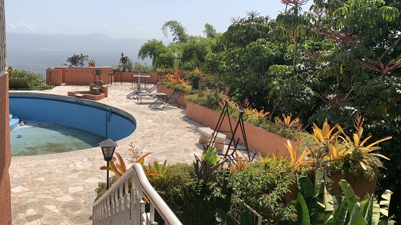 FURNISHED LUXURY MOUNTAIN ESTATE for RENT, Montagne Noire (Lower – Near Spain’s Embassy), Petion-Ville, Haiti – 4 Spacious Bedrooms, 5 Bathrooms, Office Space, Expensive Modern Antique Furniture, Modern Appliances, 24/7 Robust Solar-Powered Electricity, Backup Generator, Security Guards on Rotation, WiFi/Internet, Servant Quarter, Big Yards with Flowers, Lush Greenery & Manicured Grass, Gleaming Swimming Pool, Parking for 5+ Cars