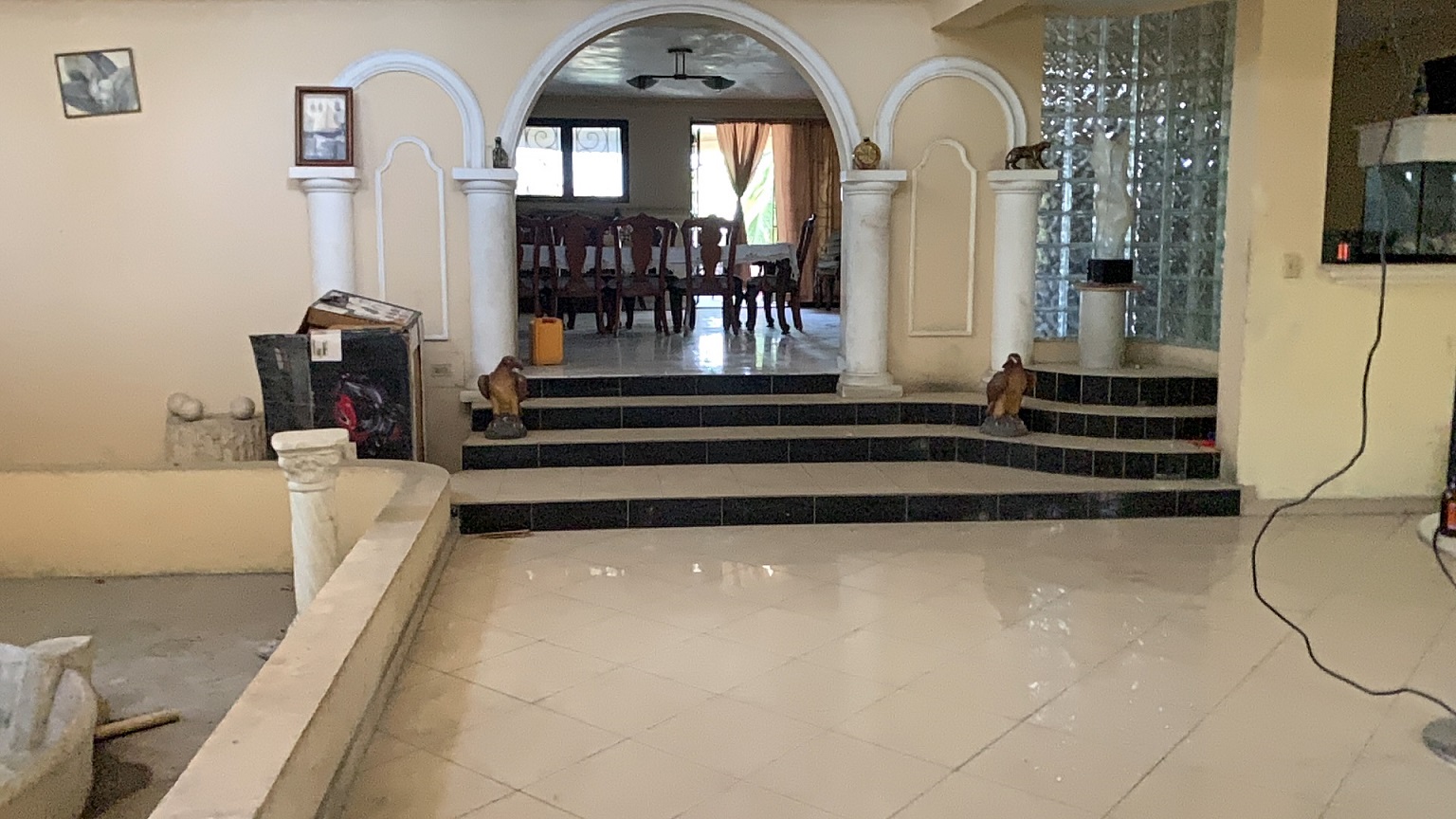 Palace-Style Villa for Sale, Vivy Mitchell, Petion-Ville, Haiti – House or Home has 6 Spacious Bedrooms, 5 1/2 Bathrooms, Multiple Grand Living & Dining Rooms, Majestic Kitchen, Whirlpool Jacuzzi Tub in Master Bedroom, Walk-in Closet, Basement Game Room & Gym, Floor-to-Ceiling Windows, Big Balconies, Terrace & Decks, Indoor & Outdoor Seating Areas, Ample Front-Back Yard Space, Reserved Space for Swimming Pool, Fruits, Vegetables, Tropical Trees, Two Gates, Brick Fence, Parking for 13+ Cars