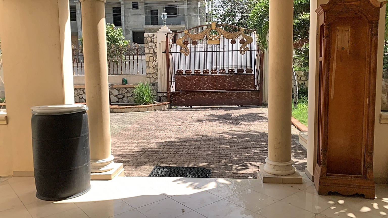 Palace-Style Villa for Sale, Vivy Mitchell, Petion-Ville, Haiti – House or Home has 6 Spacious Bedrooms, 5 1/2 Bathrooms, Multiple Grand Living & Dining Rooms, Majestic Kitchen, Whirlpool Jacuzzi Tub in Master Bedroom, Walk-in Closet, Basement Game Room & Gym, Floor-to-Ceiling Windows, Big Balconies, Terrace & Decks, Indoor & Outdoor Seating Areas, Ample Front-Back Yard Space, Reserved Space for Swimming Pool, Fruits, Vegetables, Tropical Trees, Two Gates, Brick Fence, Parking for 13+ Cars