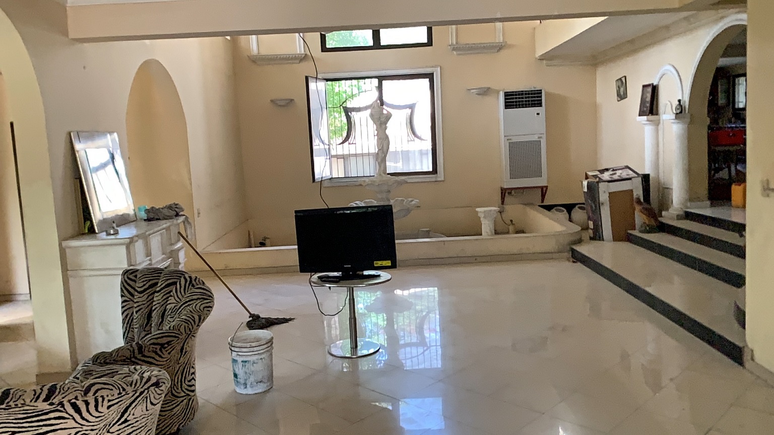 Palace-Style Villa for Sale, Vivy Mitchell, Petion-Ville, Haiti – House or Home has 6 Spacious Bedrooms, 5 1/2 Bathrooms, Multiple Grand Living & Dining Rooms, Majestic Kitchen, Whirlpool Jacuzzi Tub in Master Bedroom, Walk-in Closet, Basement Game Room & Gym, Floor-to-Ceiling Windows, Big Balconies, Terrace & Decks, Indoor & Outdoor Seating Areas, Ample Front-Back Yard Space, Reserved Space for Swimming Pool, Fruits, Vegetables, Tropical Trees, Two Gates, Brick Fence, Parking for 13+ Cars