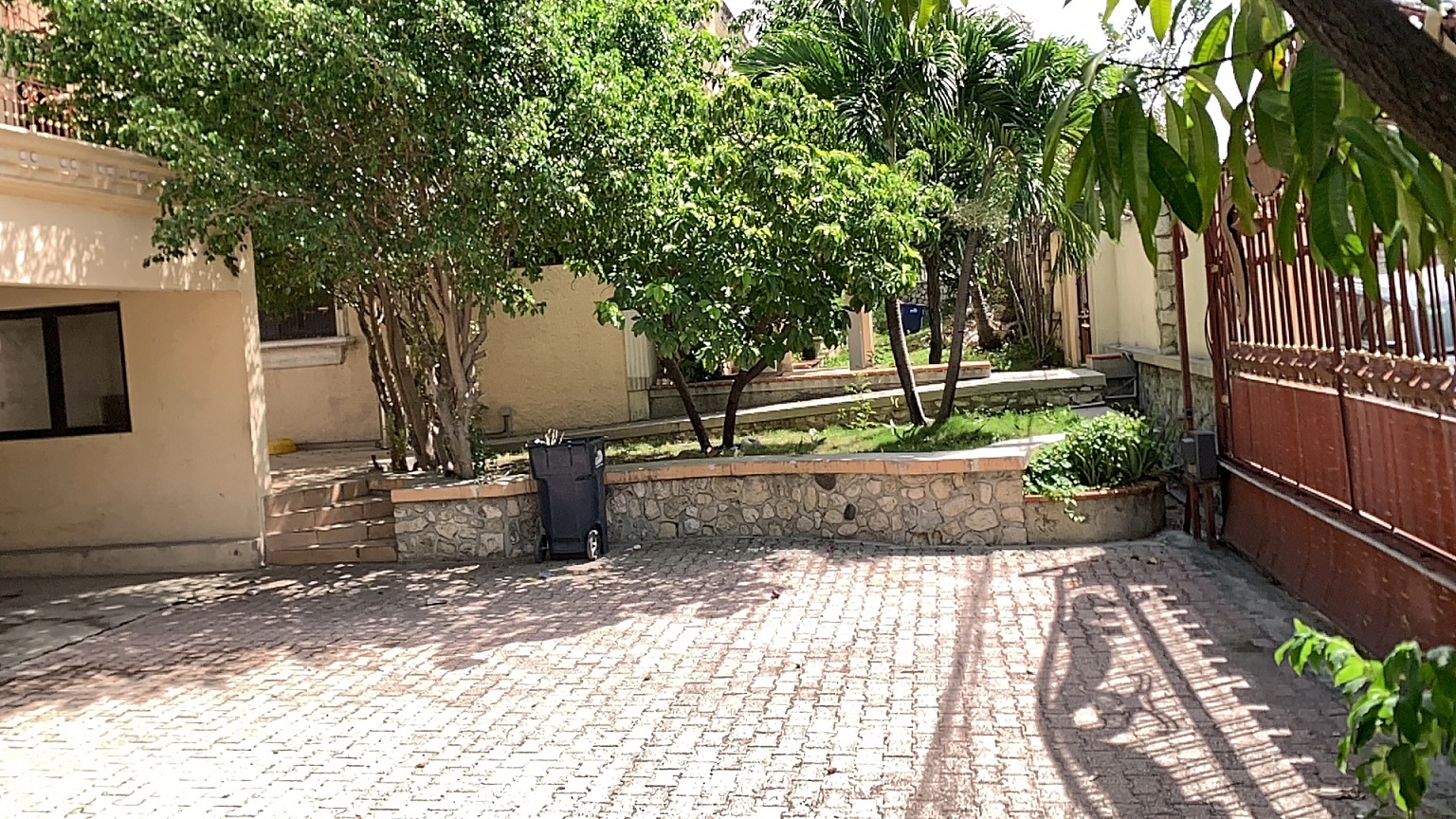 Palace-Style Villa for Sale, Vivy Mitchell, Petion-Ville, Haiti – House or Home has 6 Spacious Bedrooms, 5 1/2 Bathrooms, Multiple Grand Living & Dining Rooms, Majestic Kitchen, Whirlpool Jacuzzi Tub in Master Bedroom, Walk-in Closet, Basement Game Room & Gym, Floor-to-Ceiling Windows, Big Balconies, Terrace & Decks, Indoor & Outdoor Seating Areas, Ample Front-Back Yard Space, Reserved Space for Swimming Pool, Fruits, Vegetables, Tropical Trees, Two Gates, Brick Fence, Parking for 13+ Cars