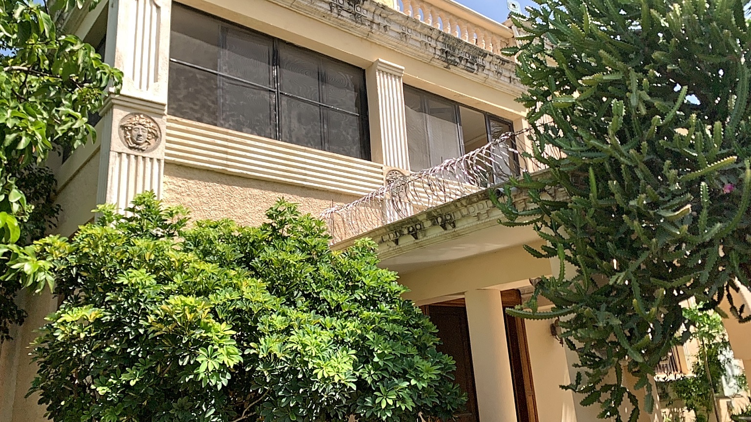Palace-Style Villa for Sale, Vivy Mitchell, Petion-Ville, Haiti – House or Home has 6 Spacious Bedrooms, 5 1/2 Bathrooms, Multiple Grand Living & Dining Rooms, Majestic Kitchen, Whirlpool Jacuzzi Tub in Master Bedroom, Walk-in Closet, Basement Game Room & Gym, Floor-to-Ceiling Windows, Big Balconies, Terrace & Decks, Indoor & Outdoor Seating Areas, Ample Front-Back Yard Space, Reserved Space for Swimming Pool, Fruits, Vegetables, Tropical Trees, Two Gates, Brick Fence, Parking for 13+ Cars