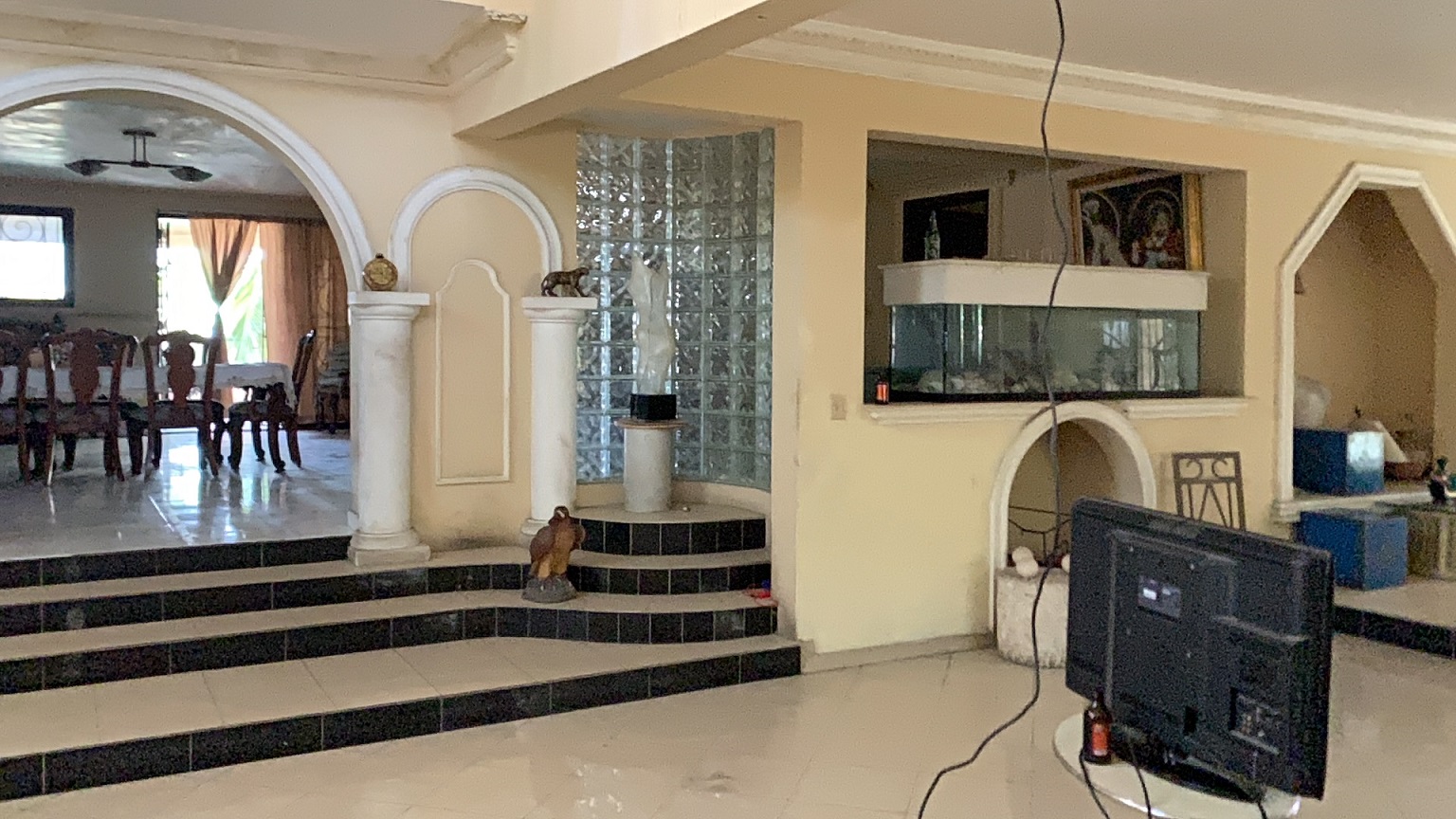 Palace-Style Villa for Sale, Vivy Mitchell, Petion-Ville, Haiti – House or Home has 6 Spacious Bedrooms, 5 1/2 Bathrooms, Multiple Grand Living & Dining Rooms, Majestic Kitchen, Whirlpool Jacuzzi Tub in Master Bedroom, Walk-in Closet, Basement Game Room & Gym, Floor-to-Ceiling Windows, Big Balconies, Terrace & Decks, Indoor & Outdoor Seating Areas, Ample Front-Back Yard Space, Reserved Space for Swimming Pool, Fruits, Vegetables, Tropical Trees, Two Gates, Brick Fence, Parking for 13+ Cars