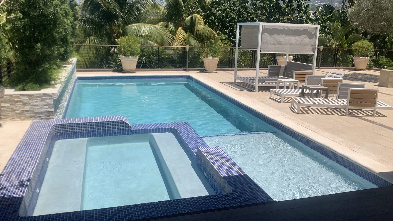 Lavish Furnished Paraseismic Mansion for Sale in Juvenat (Karibe Hotel Green Zone), Port-au-Prince, Haiti – 4 Spacious Bedrooms with Modern High-end Furniture & Appliances, Large Circular Living/Dining Rooms, 3 1/2 Stylish Bathrooms, Gourmet Kitchen, Panoramic Living/Dining Rooms, Gleaming Swimming Pool with Attached Jacuzzi, Multiple Seating Areas, Exclusive/Private Neighborhood, Robust 24/7 Solar-Powered Electricity System, Servant/Security Quarter