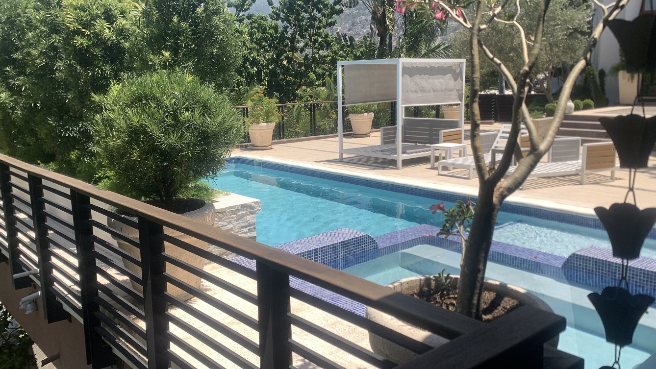 Lavish Furnished Paraseismic Mansion for Sale in Juvenat (Karibe Hotel Green Zone), Port-au-Prince, Haiti – 4 Spacious Bedrooms with Modern High-end Furniture & Appliances, Large Circular Living/Dining Rooms, 3 1/2 Stylish Bathrooms, Gourmet Kitchen, Panoramic Living/Dining Rooms, Gleaming Swimming Pool with Attached Jacuzzi, Multiple Seating Areas, Exclusive/Private Neighborhood, Robust 24/7 Solar-Powered Electricity System, Servant/Security Quarter