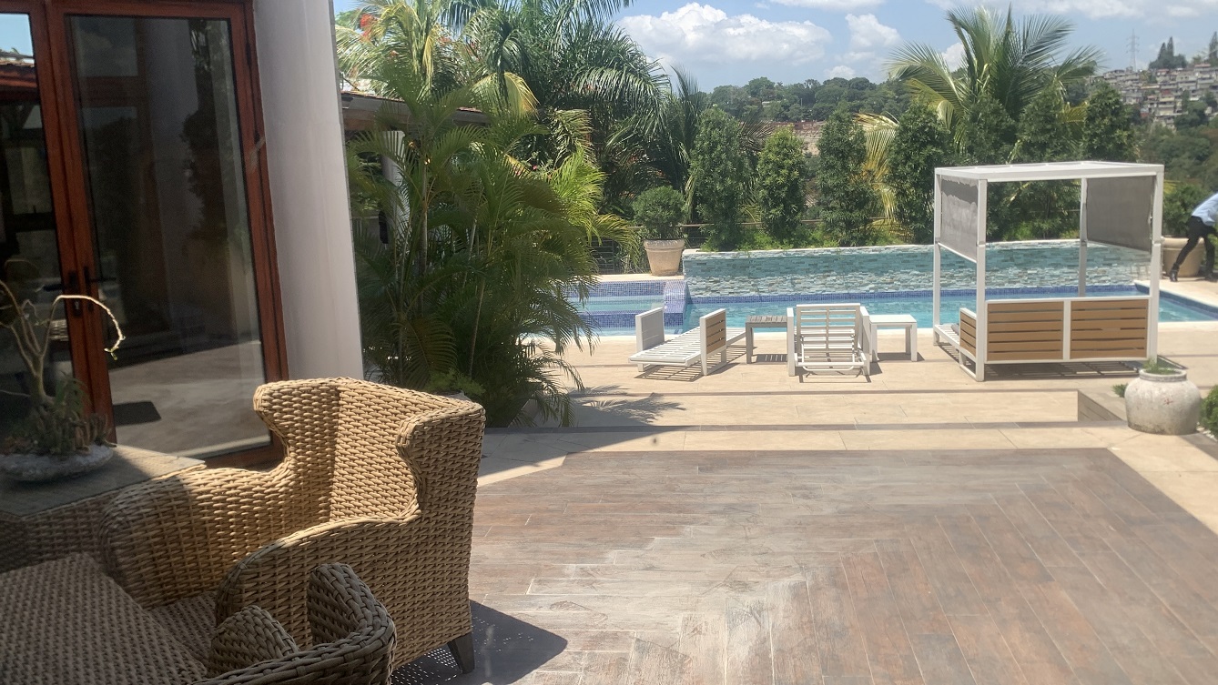 Lavish Furnished Paraseismic Mansion for Sale in Juvenat (Karibe Hotel Green Zone), Port-au-Prince, Haiti – 4 Spacious Bedrooms with Modern High-end Furniture & Appliances, Large Circular Living/Dining Rooms, 3 1/2 Stylish Bathrooms, Gourmet Kitchen, Panoramic Living/Dining Rooms, Gleaming Swimming Pool with Attached Jacuzzi, Multiple Seating Areas, Exclusive/Private Neighborhood, Robust 24/7 Solar-Powered Electricity System, Servant/Security Quarter
