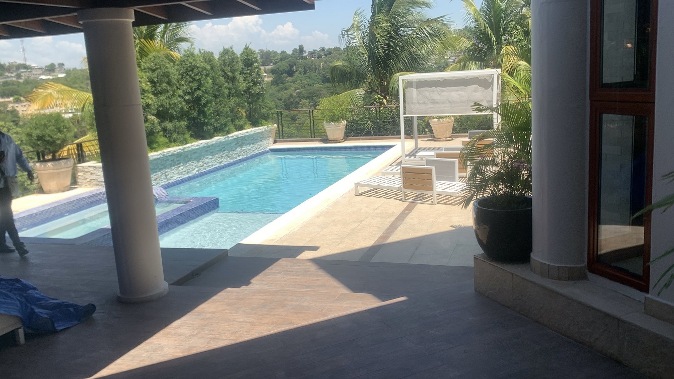 Lavish Furnished Paraseismic Mansion for Sale in Juvenat (Karibe Hotel Green Zone), Port-au-Prince, Haiti – 4 Spacious Bedrooms with Modern High-end Furniture & Appliances, Large Circular Living/Dining Rooms, 3 1/2 Stylish Bathrooms, Gourmet Kitchen, Panoramic Living/Dining Rooms, Gleaming Swimming Pool with Attached Jacuzzi, Multiple Seating Areas, Exclusive/Private Neighborhood, Robust 24/7 Solar-Powered Electricity System, Servant/Security Quarter