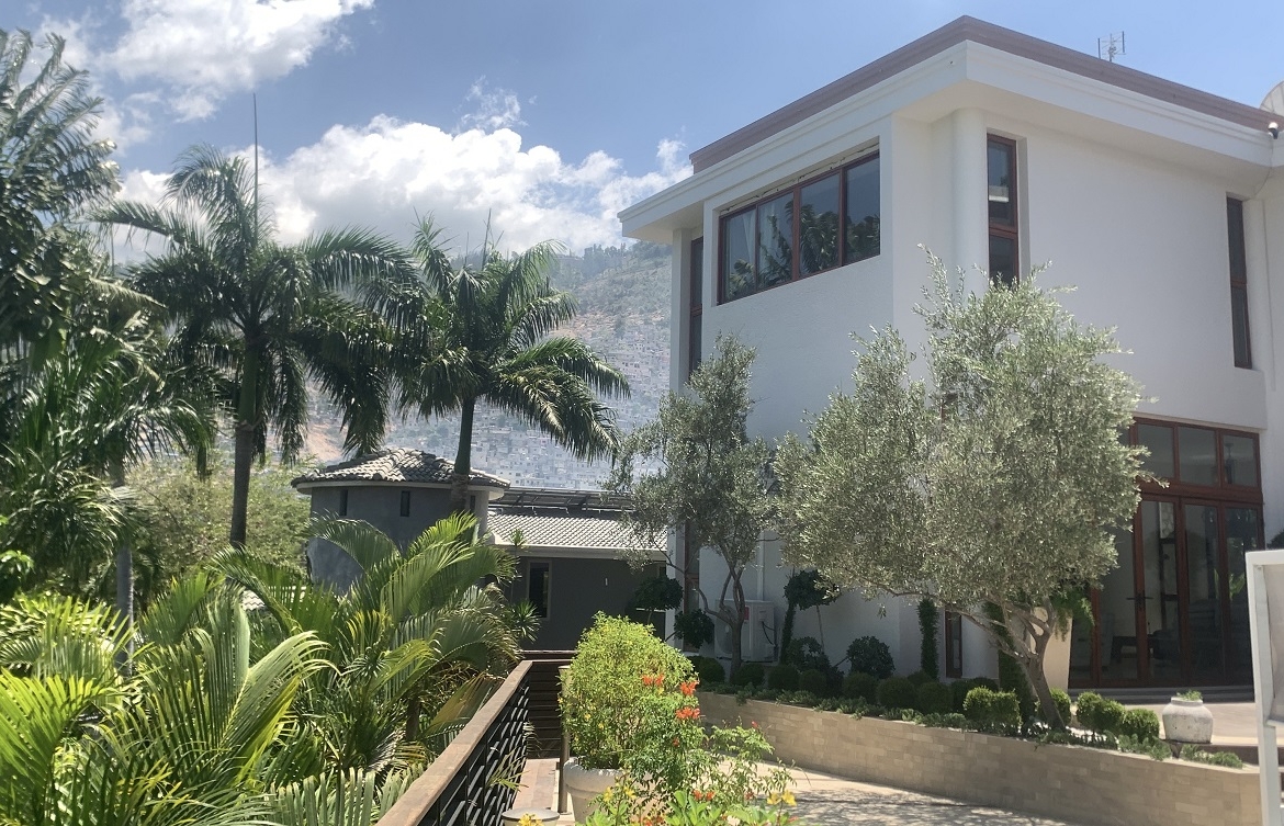 Lavish Furnished Paraseismic Mansion for Sale in Juvenat (Karibe Hotel Green Zone), Port-au-Prince, Haiti – 4 Spacious Bedrooms with Modern High-end Furniture & Appliances, Large Circular Living/Dining Rooms, 3 1/2 Stylish Bathrooms, Gourmet Kitchen, Panoramic Living/Dining Rooms, Gleaming Swimming Pool with Attached Jacuzzi, Multiple Seating Areas, Exclusive/Private Neighborhood, Robust 24/7 Solar-Powered Electricity System, Servant/Security Quarter