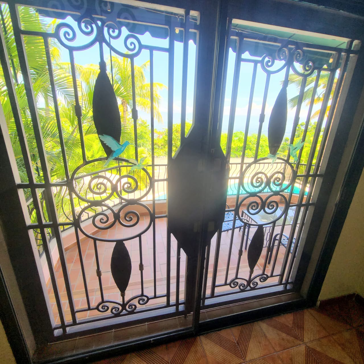 Stunning Furnished House for SALE in Lower Morne Calvaire, Petion-Ville, Haiti – 3 Spacious Bedrooms with Modern High-end Furniture & Appliances, Capacious Living/Dining Rooms, 3 1/2 Stylish Bathrooms, Gourmet Kitchen, Panoramic Living/Dining Rooms, Radiant Swimming Pool with Chairs, Chaise Loungers, & Tables, Multiple Seating Areas, Exclusive/Private Neighborhood, Robust 24/7 Solar-Powered Electricity System, Servant/Security Quarters, Manicure, Lush Green Trees