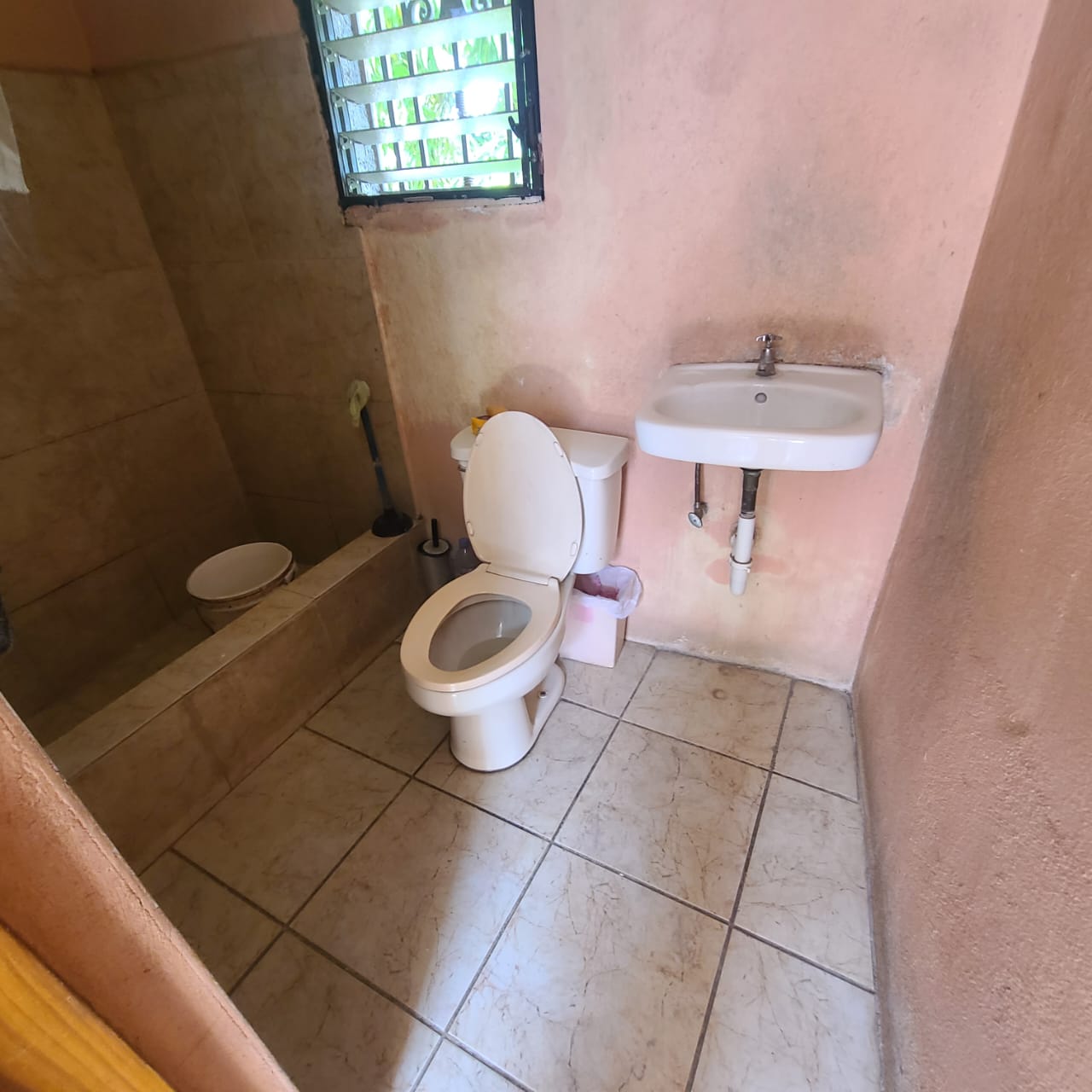 Stunning Furnished House for SALE in Lower Morne Calvaire, Petion-Ville, Haiti – 3 Spacious Bedrooms with Modern High-end Furniture & Appliances, Capacious Living/Dining Rooms, 3 1/2 Stylish Bathrooms, Gourmet Kitchen, Panoramic Living/Dining Rooms, Radiant Swimming Pool with Chairs, Chaise Loungers, & Tables, Multiple Seating Areas, Exclusive/Private Neighborhood, Robust 24/7 Solar-Powered Electricity System, Servant/Security Quarters, Manicure, Lush Green Trees