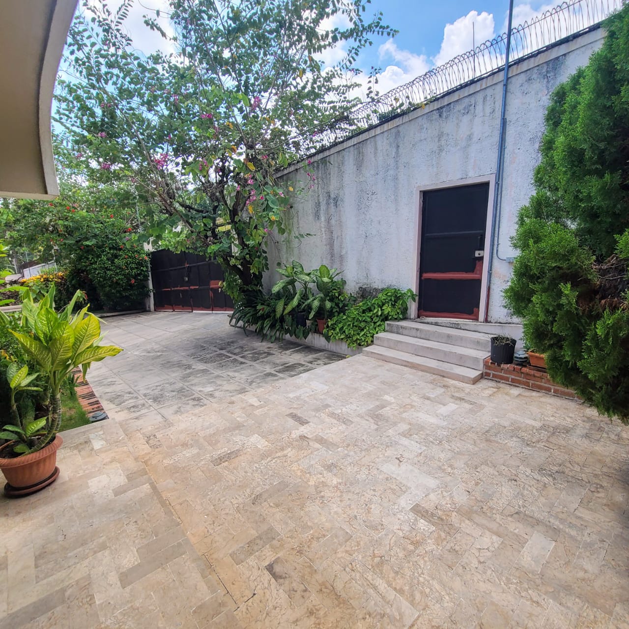 Stunning Furnished House for SALE in Lower Morne Calvaire, Petion-Ville, Haiti – 3 Spacious Bedrooms with Modern High-end Furniture & Appliances, Capacious Living/Dining Rooms, 3 1/2 Stylish Bathrooms, Gourmet Kitchen, Panoramic Living/Dining Rooms, Radiant Swimming Pool with Chairs, Chaise Loungers, & Tables, Multiple Seating Areas, Exclusive/Private Neighborhood, Robust 24/7 Solar-Powered Electricity System, Servant/Security Quarters, Manicure, Lush Green Trees