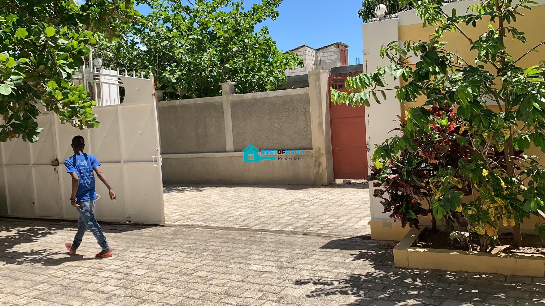 Beautiful, 3-Story, Mega Furnished House For Sale in Santo 17, Port-au-Prince, Haiti – 8 Spacious Bedrooms with Walk-in Closets, 7 Bathrooms, Multiple Living & Dining Rooms, Modern Kitchen, Floor-to-Ceiling Windows, Several Balconies, Servant Quarters, Big Yards/Gardens, 80-foot Artesian Well, High Fences, 2 Iron Gates, Lots of Parking Spaces
