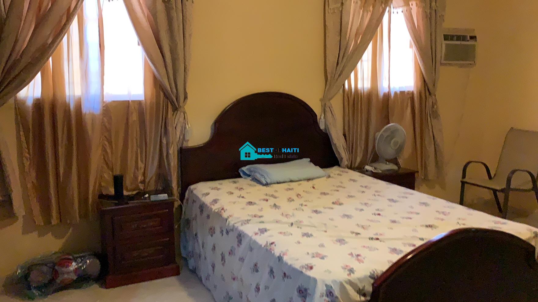 Beautiful, 3-Story, Mega Furnished House For Sale in Santo 17, Port-au-Prince, Haiti – 8 Spacious Bedrooms with Walk-in Closets, 7 Bathrooms, Multiple Living & Dining Rooms, Modern Kitchen, Floor-to-Ceiling Windows, Several Balconies, Servant Quarters, Big Yards/Gardens, 80-foot Artesian Well, High Fences, 2 Iron Gates, Lots of Parking Spaces