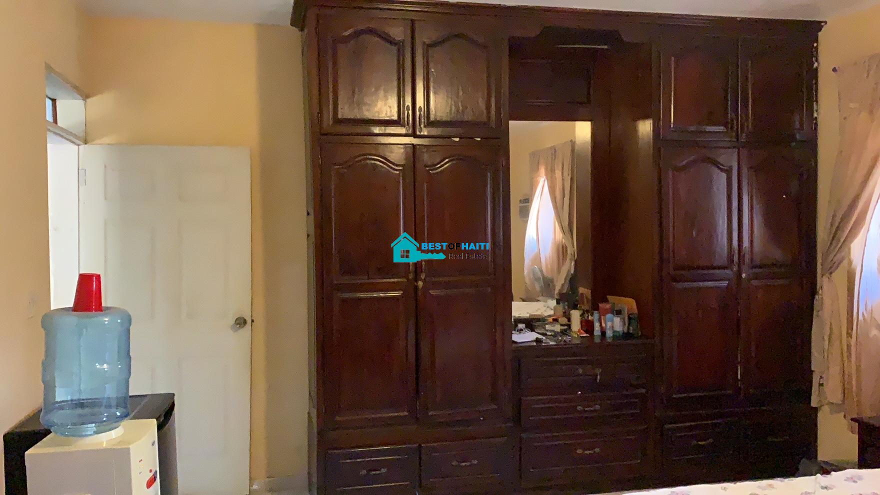 Beautiful, 3-Story, Mega Furnished House For Sale in Santo 17, Port-au-Prince, Haiti – 8 Spacious Bedrooms with Walk-in Closets, 7 Bathrooms, Multiple Living & Dining Rooms, Modern Kitchen, Floor-to-Ceiling Windows, Several Balconies, Servant Quarters, Big Yards/Gardens, 80-foot Artesian Well, High Fences, 2 Iron Gates, Lots of Parking Spaces