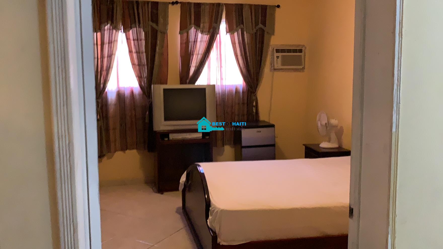 Beautiful, 3-Story, Mega Furnished House For Sale in Santo 17, Port-au-Prince, Haiti – 8 Spacious Bedrooms with Walk-in Closets, 7 Bathrooms, Multiple Living & Dining Rooms, Modern Kitchen, Floor-to-Ceiling Windows, Several Balconies, Servant Quarters, Big Yards/Gardens, 80-foot Artesian Well, High Fences, 2 Iron Gates, Lots of Parking Spaces