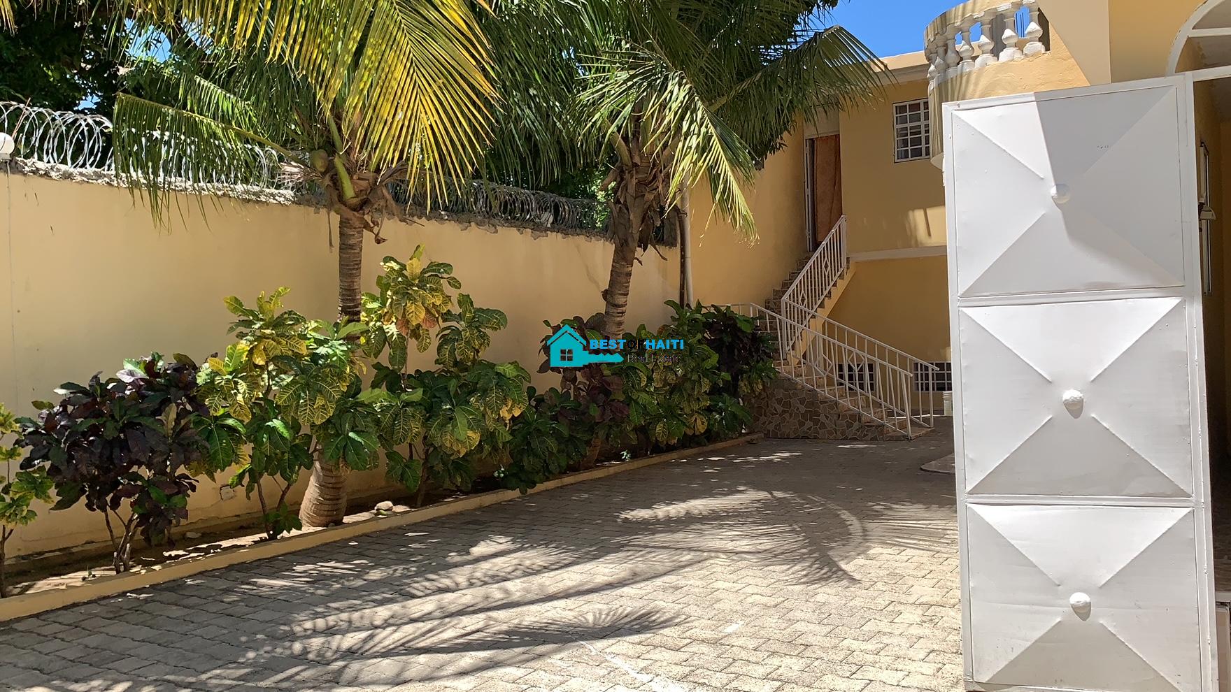 Beautiful, 3-Story, Mega Furnished House For Sale in Santo 17, Port-au-Prince, Haiti – 8 Spacious Bedrooms with Walk-in Closets, 7 Bathrooms, Multiple Living & Dining Rooms, Modern Kitchen, Floor-to-Ceiling Windows, Several Balconies, Servant Quarters, Big Yards/Gardens, 80-foot Artesian Well, High Fences, 2 Iron Gates, Lots of Parking Spaces