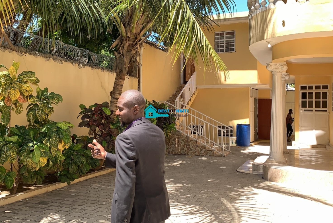 Beautiful, 3-Story, Mega Furnished House For Sale in Santo 17, Port-au-Prince, Haiti – 8 Spacious Bedrooms with Walk-in Closets, 7 Bathrooms, Multiple Living & Dining Rooms, Modern Kitchen, Floor-to-Ceiling Windows, Several Balconies, Servant Quarters, Big Yards/Gardens, 80-foot Artesian Well, High Fences, 2 Iron Gates, Lots of Parking Spaces