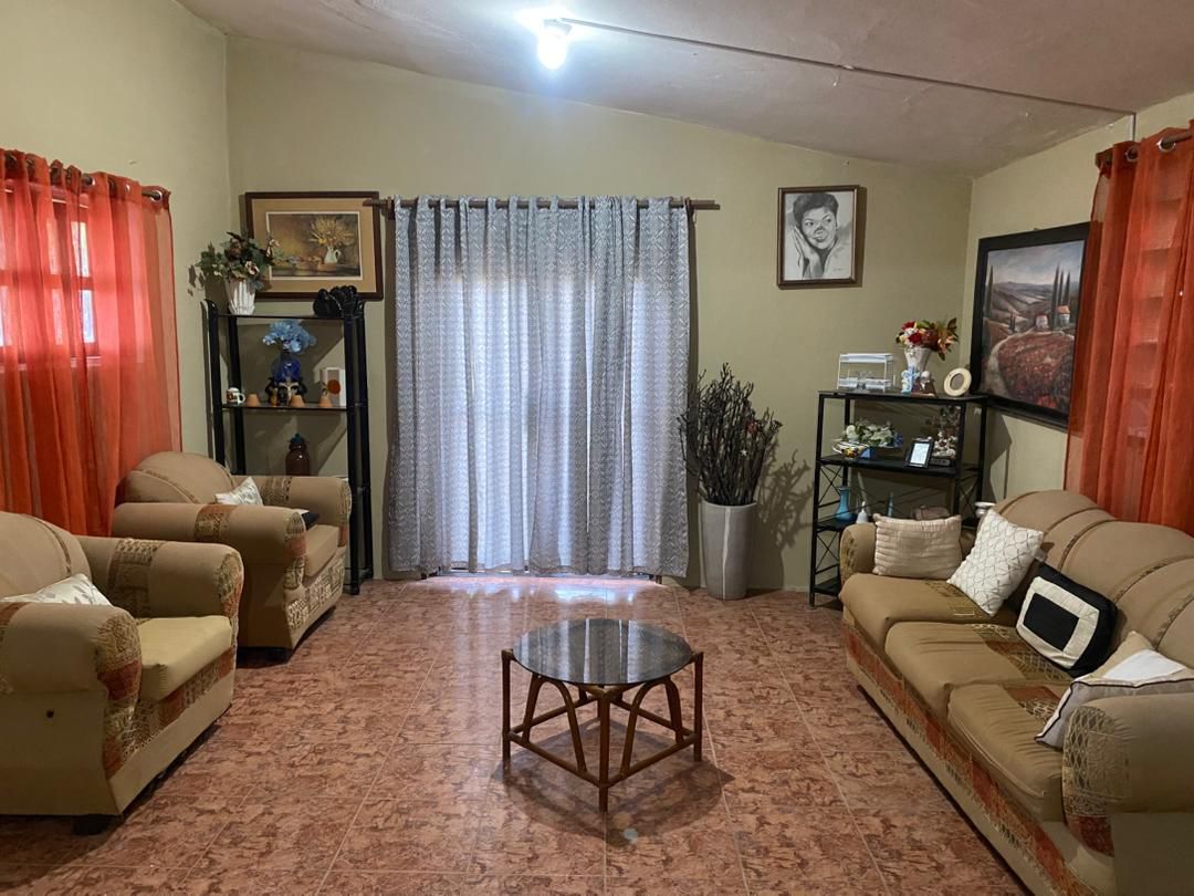 Move-in Ready Furnished Apartment for RENT in Petite Anse, Cap-Haïtien, Haiti – 2 Bedrooms, 1 Bathroom, Living/Dining Rooms with Clean Furniture & Appliances, Modern Kitchen, Large Upper Balcony with Views, Fans, Washer/Dryer, High-Speed Internet, Television (TV), Solar-Powered Electricity, Indoor Parking for 1 Car