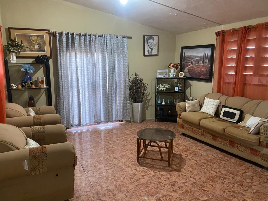 Move-in Ready Furnished Apartment for RENT in Petite Anse, Cap-Haïtien, Haiti – 2 Bedrooms, 1 Bathroom, Living/Dining Rooms with Clean Furniture & Appliances, Modern Kitchen, Large Upper Balcony with Views, Fans, Washer/Dryer, High-Speed Internet, Television (TV), Solar-Powered Electricity, Indoor Parking for 1 Car
