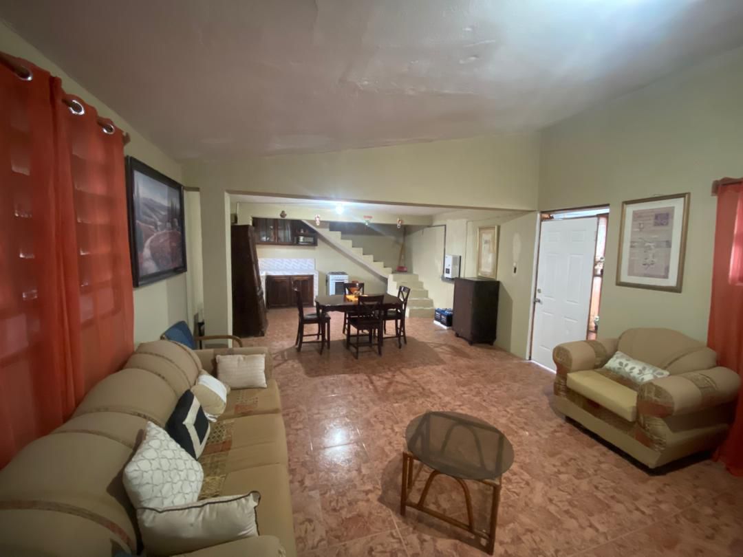 Move-in Ready Furnished Apartment for RENT in Petite Anse, Cap-Haïtien, Haiti – 2 Bedrooms, 1 Bathroom, Living/Dining Rooms with Clean Furniture & Appliances, Modern Kitchen, Large Upper Balcony with Views, Fans, Washer/Dryer, High-Speed Internet, Television (TV), Solar-Powered Electricity, Indoor Parking for 1 Car