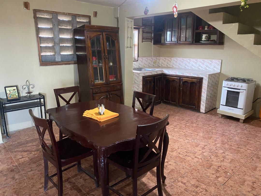 Move-in Ready Furnished Apartment for RENT in Petite Anse, Cap-Haïtien, Haiti – 2 Bedrooms, 1 Bathroom, Living/Dining Rooms with Clean Furniture & Appliances, Modern Kitchen, Large Upper Balcony with Views, Fans, Washer/Dryer, High-Speed Internet, Television (TV), Solar-Powered Electricity, Indoor Parking for 1 Car
