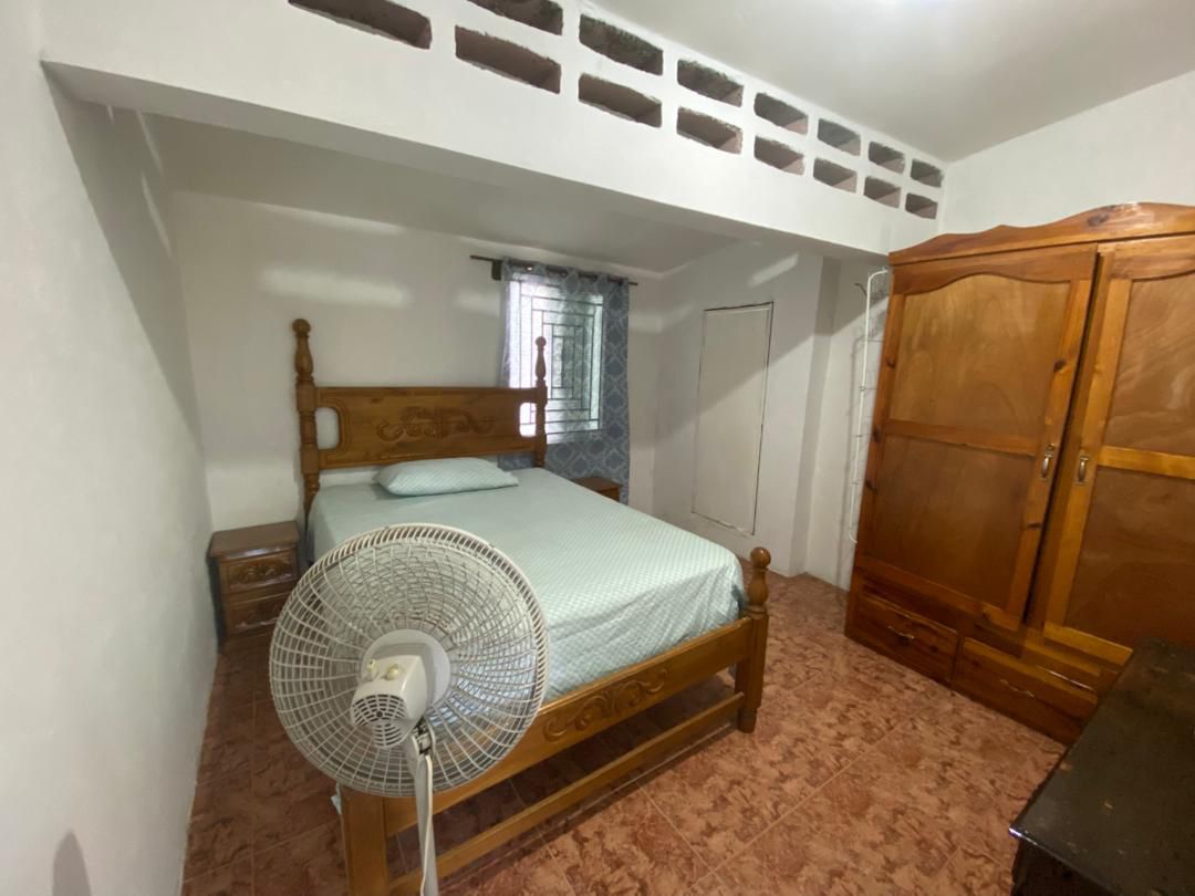 Move-in Ready Furnished Apartment for RENT in Petite Anse, Cap-Haïtien, Haiti – 2 Bedrooms, 1 Bathroom, Living/Dining Rooms with Clean Furniture & Appliances, Modern Kitchen, Large Upper Balcony with Views, Fans, Washer/Dryer, High-Speed Internet, Television (TV), Solar-Powered Electricity, Indoor Parking for 1 Car