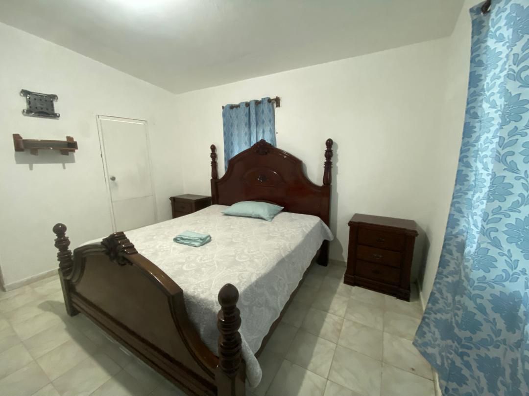 Move-in Ready Furnished Apartment for RENT in Petite Anse, Cap-Haïtien, Haiti – 2 Bedrooms, 1 Bathroom, Living/Dining Rooms with Clean Furniture & Appliances, Modern Kitchen, Large Upper Balcony with Views, Fans, Washer/Dryer, High-Speed Internet, Television (TV), Solar-Powered Electricity, Indoor Parking for 1 Car