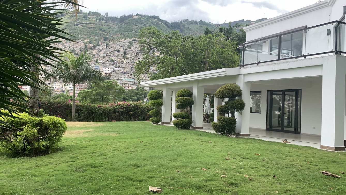Newly Renovated FURNISHED MEGA LUXURY HOUSE for SALE, Juvenat (Yards from Karibe Hotel), Petion-Ville, Haiti – 4 Spacious Bedrooms, 3 1/2 Baths, Brand New Modern Furniture & Appliances,  Contemporary Island Kitchen, Manicured Backyard, Space for Sparkling Swimming Pool, 24/7 Robust Solar-Powered Electricity, Backup Generator, Security Guards on Rotation, WiFi/Internet, Servant Quarter, 10+ Parking Spaces, Lots of Greenery, Fruit, Vegetable, Tropical Trees, and More…