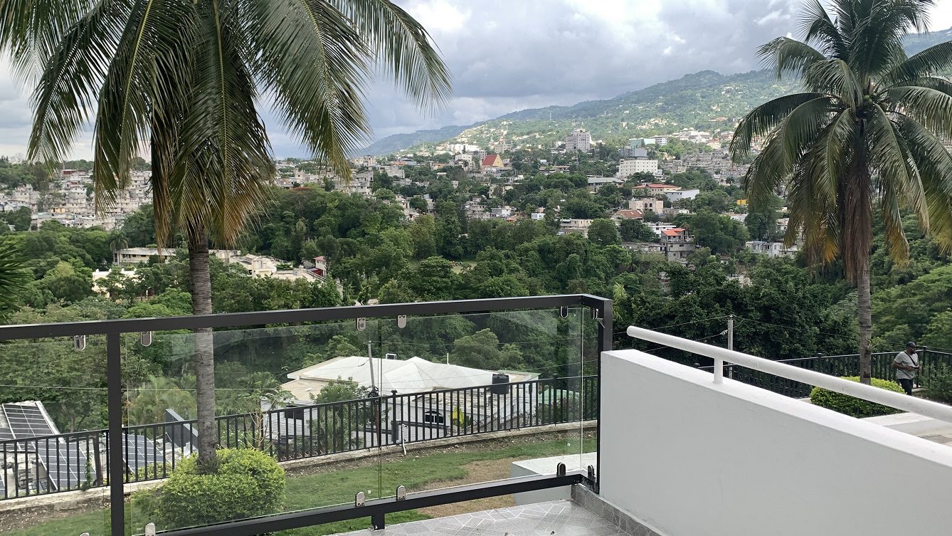 Newly Renovated FURNISHED MEGA LUXURY HOUSE for SALE, Juvenat (Yards from Karibe Hotel), Petion-Ville, Haiti – 4 Spacious Bedrooms, 3 1/2 Baths, Brand New Modern Furniture & Appliances,  Contemporary Island Kitchen, Manicured Backyard, Space for Sparkling Swimming Pool, 24/7 Robust Solar-Powered Electricity, Backup Generator, Security Guards on Rotation, WiFi/Internet, Servant Quarter, 10+ Parking Spaces, Lots of Greenery, Fruit, Vegetable, Tropical Trees, and More…