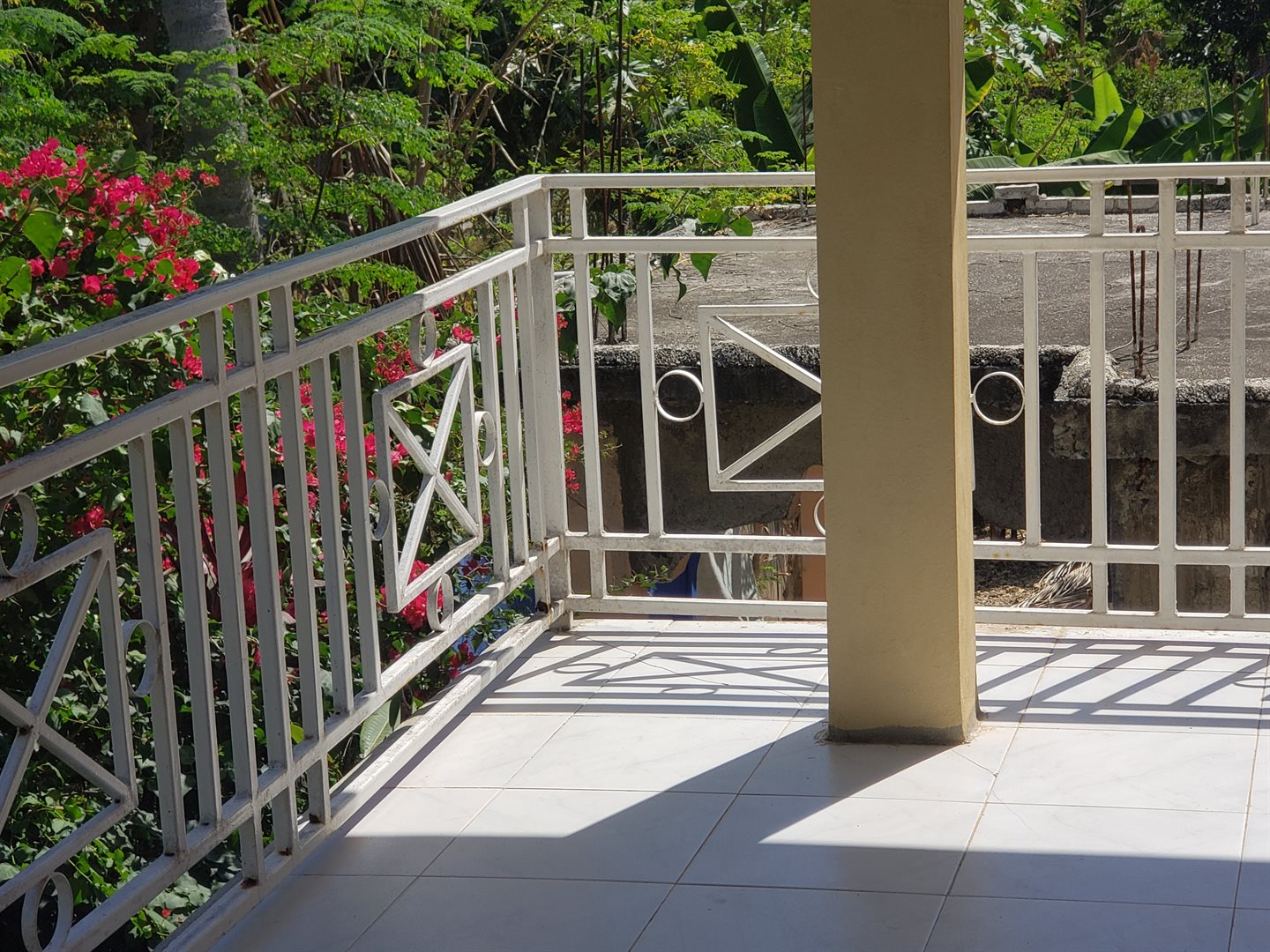 Two-Story House + Apartment + Land for Sale (PACKAGE DEAL) in Meyer, Jacmel, Haiti – 4 Spacious Bedrooms with Built-in Closets, 3 Bathrooms with Glamorous Bathtubs, Living/Dining Rooms, Nice Modern Kitchen, Wrap-Around Patio with Beautiful Flowers, Two Balconies, Family Room, Upstairs Loft, Solar-Powered Electricity System, Panoramic Views – An Apartment of 2 Bedrooms, 1 Bath, Kitchen – Piece of Land of 5 Centiemes (650 m² or 6996.54 ft²)