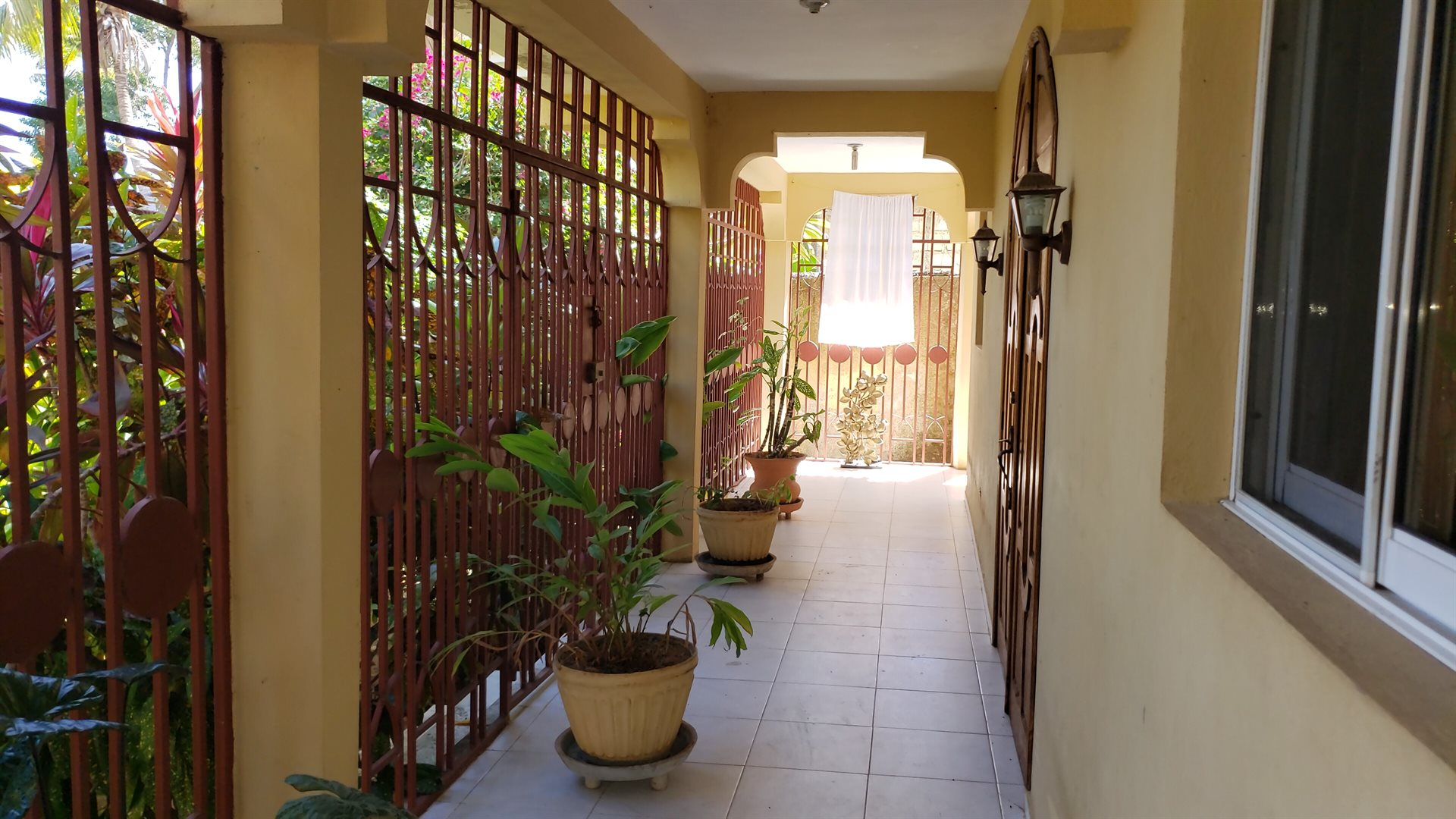 Two-Story House + Apartment + Land for Sale (PACKAGE DEAL) in Meyer, Jacmel, Haiti – 4 Spacious Bedrooms with Built-in Closets, 3 Bathrooms with Glamorous Bathtubs, Living/Dining Rooms, Nice Modern Kitchen, Wrap-Around Patio with Beautiful Flowers, Two Balconies, Family Room, Upstairs Loft, Solar-Powered Electricity System, Panoramic Views – An Apartment of 2 Bedrooms, 1 Bath, Kitchen – Piece of Land of 5 Centiemes (650 m² or 6996.54 ft²)